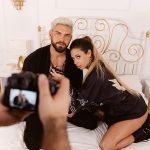 couple taking part in erotic photo shoot on bed