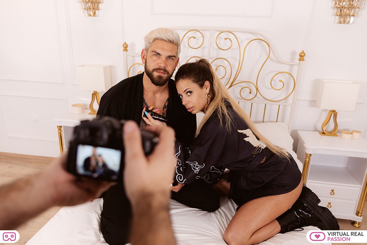 couple taking part in erotic photo shoot on bed