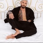 Juan Lucho in black kimono on bed