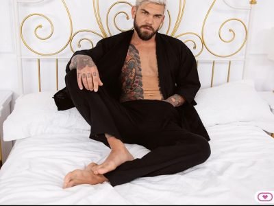 Juan Lucho in black kimono on bed