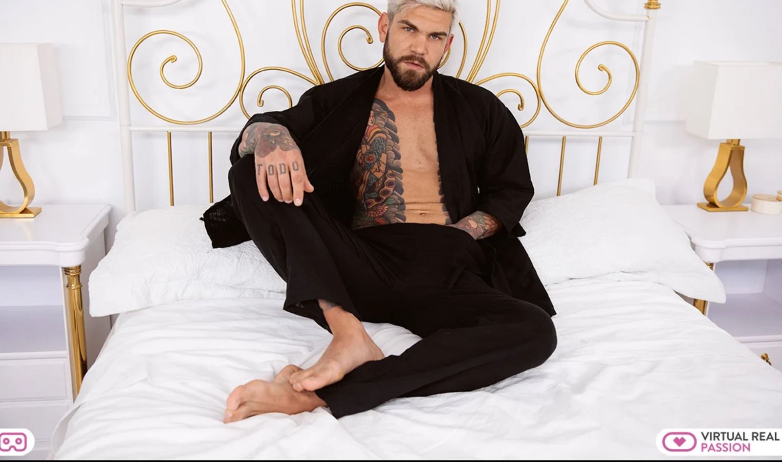 Juan Lucho in black kimono on bed