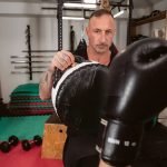 mma personal trainer holds pads