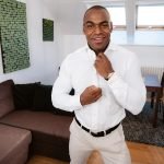 smooth black man in white suit Aaron Rock