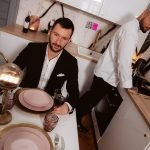 woman sits at dinner table with suited man