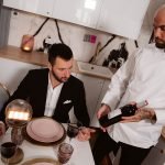 private chef serves couple their meal at the table