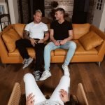 two bisexual men sitting on sofa