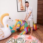 Lando Ryder in shorts with inflatable toys.